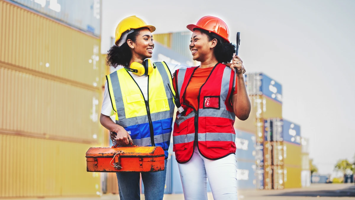 Two women working at industrial job site