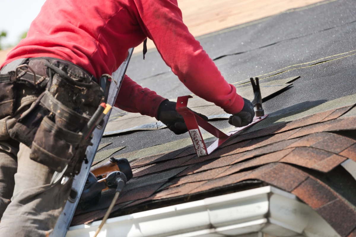Tradesman repairs roof